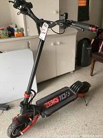 Side profile of scooter showing deck, handlebar column and 10-inch front wheel.