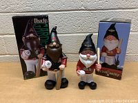 Photo of 2 Arizona Diamondbacks garden gnomes with their original boxes, showing details and scale.
