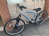 Side view of the men's Huffy mountain bike showing frame, tires, and drivetrain components