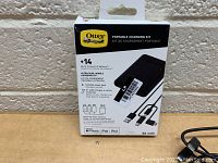 Front side of OtterBox Portable Charging Kit box showing product features and capacity of 5000mAh.