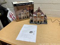 Porcelain fiber optic house on table with box and instruction sheet
