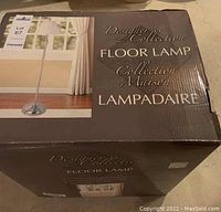 Box showing Designer Collection Floor Lamp with image of lamp and front branding.