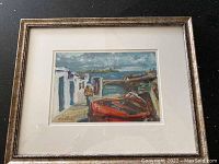 Framed seaside painting by R. OFarrell showing coastal scene with boat, figure, and buildings.