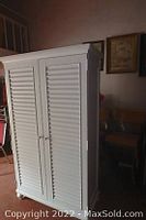 Front exterior view of closed armoire in room