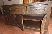 Front view of buffet with top drawers partially open and bottom doors open showing interior shelf