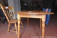 Table and chair set showing solid maple finish and turned legs of table and spindle-back chair design.