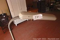 Side view of beige OttLite floor lamp with adjustable gooseneck and elongated lamp head showing brand label and lamp number 54.