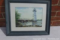 Front view of the framed laser print of Rock Island Light lighthouse with figures by Wendy M Cannon