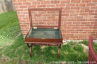 View of the wooden shadow box table with the hinged glass top open showing the interior lined compartment.