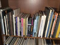 Full shelf of art and design books showing spines of various titles