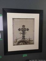 Photo shows the full framed and matted cibachrome photograph of a decorative iron cross and gate with the word 'REGRETS' visible, image has black frame and white mat.