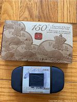 Closed packaging of the 150th Anniversary Canadian Postage Stamp set and Polar Bear 2000 Stamp and Coin set in blue case.