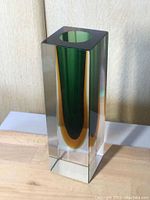 Front angle of Murano Sommerso glass vase showing green and amber inner glass inside clear rectangular prism