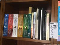 Bookshelf with George R.R. Martin's A Song of Ice and Fire series and motivational and reference books
