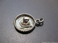 Close-up angled photo showing the detailed back and side edge of the 925 silver sombrero charm with loop attachment.