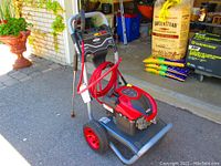 Front-left angled view of entire unit showing engine, frame and hose