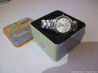 Photo showing Fossil men's stainless steel watch inside original padded metal box.