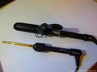 Side-by-side image of Hot Tools curling wand (3/8" gold barrel) and Babyliss Pro ceramic curling iron (1.5" black barrel; clamp on handle)