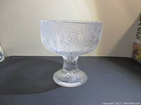 Front angled view of the textured heavy glass pedestal dish, showing the bowl and base.