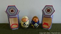 Two handmade wooden wobble dolls representing Toronto Maple Leafs players with original NHL branded hexagonal packaging, shown outside the boxes.