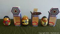 Three handmade wooden wobble dolls representing Florida Panthers NHL players with their original boxes, showing front views of the dolls outside the boxes.