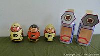 Three wooden wobble doll NHL Philadelphia Flyers players: one loose in cream jersey with black and orange details, two in original hexagonal boxes with orange jerseys and NHL/Stars themed boxes.
