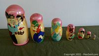 Full set of 7 nesting dolls from largest to smallest showing hand-painted Disney Pinocchio characters