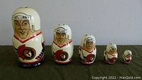 Five wooden nesting dolls hand-painted with Ottawa Senators players in hockey gear, arranged from largest to smallest, showing hand-carved and varnished details.