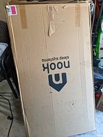 Closed cardboard box of the mattress showing Nook Sleep Systems logo.