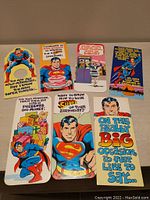 Front view of seven vintage 1978 Mark 1 Superman and Friends greeting cards showing full colorful comic style illustrations and birthday messages on card fronts.