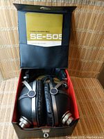 Pioneer SE-505 headphones inside carrying case with operating guide