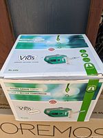 Closed original box for Vios Aerosol Delivery System nebulizer showing product branding and eco-friendly messaging.