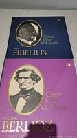 Two boxed sets of Great Men of Music vinyl records featuring Jean Sibelius and Hector Berlioz covers.