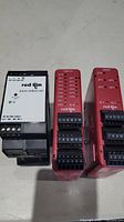 Front view of three Red Lion control components showing model numbers and terminal connectors