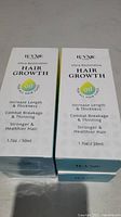 Four 1.7oz (50ml) boxed bottles of IUXNE Care Ultra-Restorative Hair Growth Oil with product benefits visible on the front of the boxes.