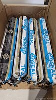 View of 8 tubes of AD SEAL silicone sealant inside an open cardboard box, showing labels and full lot quantity.