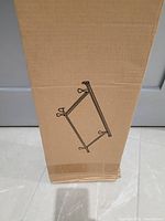 Original unopened cardboard box containing the metal frame for a double size bed.
