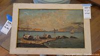 Full view of the framed oil painting depicting coastal scene with boats and figures on shore.