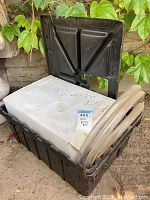 Pump kit contents including black plastic storage box with hinged lid and clear flexible tubing coiled and partially inside box