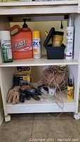 Full photo of rolling cart shelves showing hand cleaner, gloves, tools, twine, flashlight, and lubricant oil.
