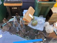 Wide photo showing entire lot including desk lamp with three globes, glass light shades, and tea light holder.