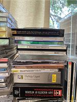 Stack of classical music CDs including Mahler Symphony No. 5, Beethoven The Five Piano Concertos, Ligeti La Grand Macabre