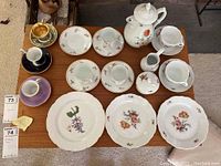Overhead shot of all porcelain china pieces arranged on wood table