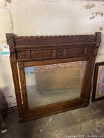 Front view of the antique Victorian Eastlake carved walnut mirror showing the full rectangular frame and mirror surface.