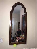 Front view of wood veneer mirror showing full frame and reflection of room.