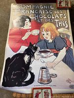 Theophile Steinlein chocolate and tea advertisement poster featuring two girls and a cat drinking tea from cups, signed Steinlein with printer stamp in corner.