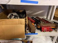 Overview photo of boxed Lionel train cars and the red Freihofer bakery delivery truck bank on a shelf