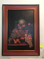Full view of the Mexican still life painting showing fruit and vessels with decorative frame