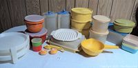 Photo showing full assortment of plastic pitchers, containers, bowls, measuring spoons, pie servers, shakers, strainer, hot plate, and Melmac dishes