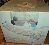 Closed original box of Conair Thermal Spa Bath Mat showing product image and branding on the packaging.